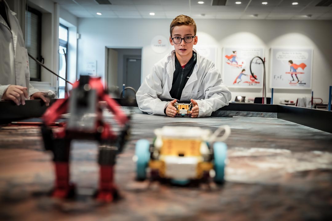 A pupil using a robot in the Newton Room